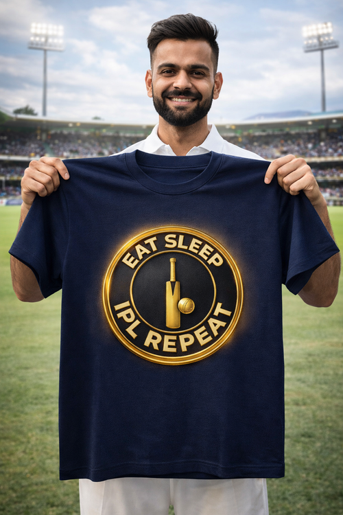 Man holding a Laveros  navy blue t-shirt with 'Eat Sleep IPL Repeat' print on a sports field 